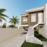 A escadaria frontal leva à entrada principal, cercada por um jardim bem cuidado que dão um toque tropical ao ambiente.